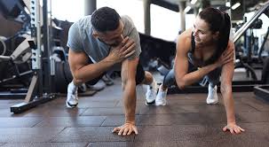 Image of man and woman doing Cardio Banstead to tone their arms. 